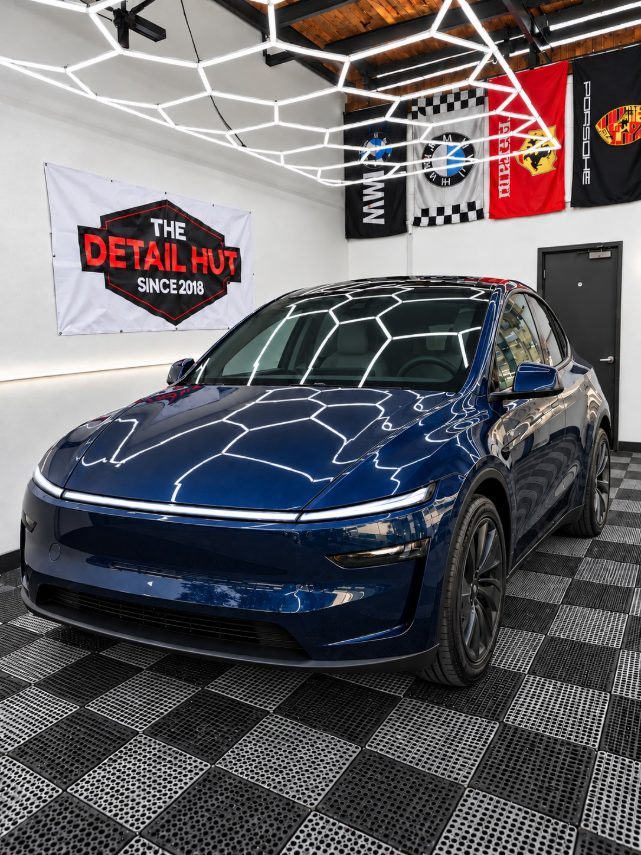 Deep blue Tesla Model Y in The Detail Hut install bay
